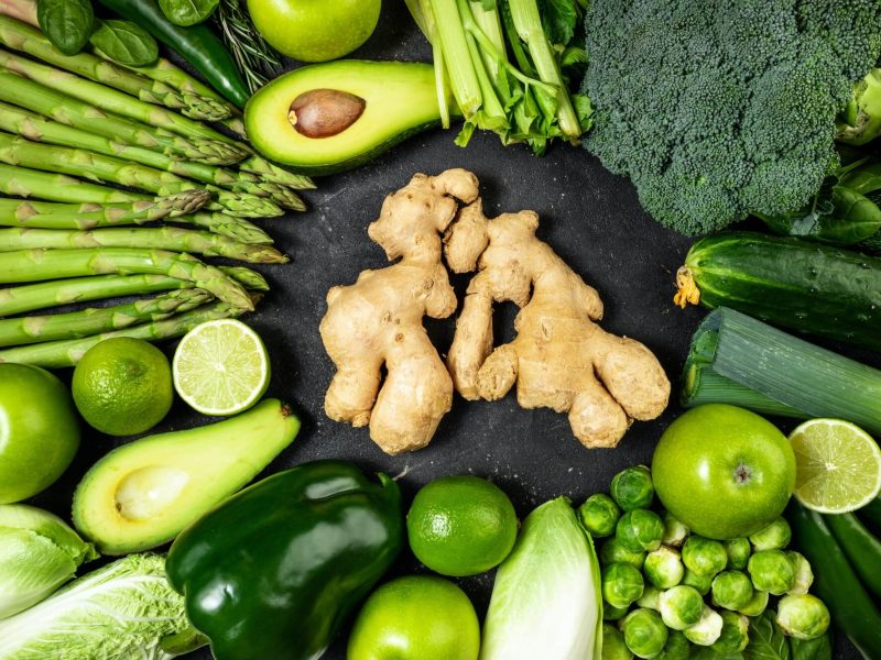 healthy-food-clean-eating-green-vegetables-fruits-and-ginger-on-dark-stone-background-1.jpg